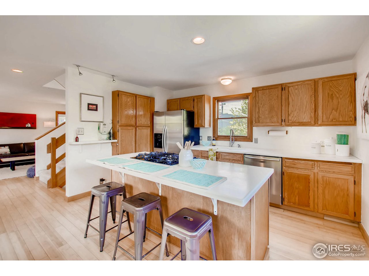 4110 Riverside Avenue Boulder, CO 80304 - Photo 15 of 39 a kitchen with stainless steel appliances a table chairs refrigerator and sink