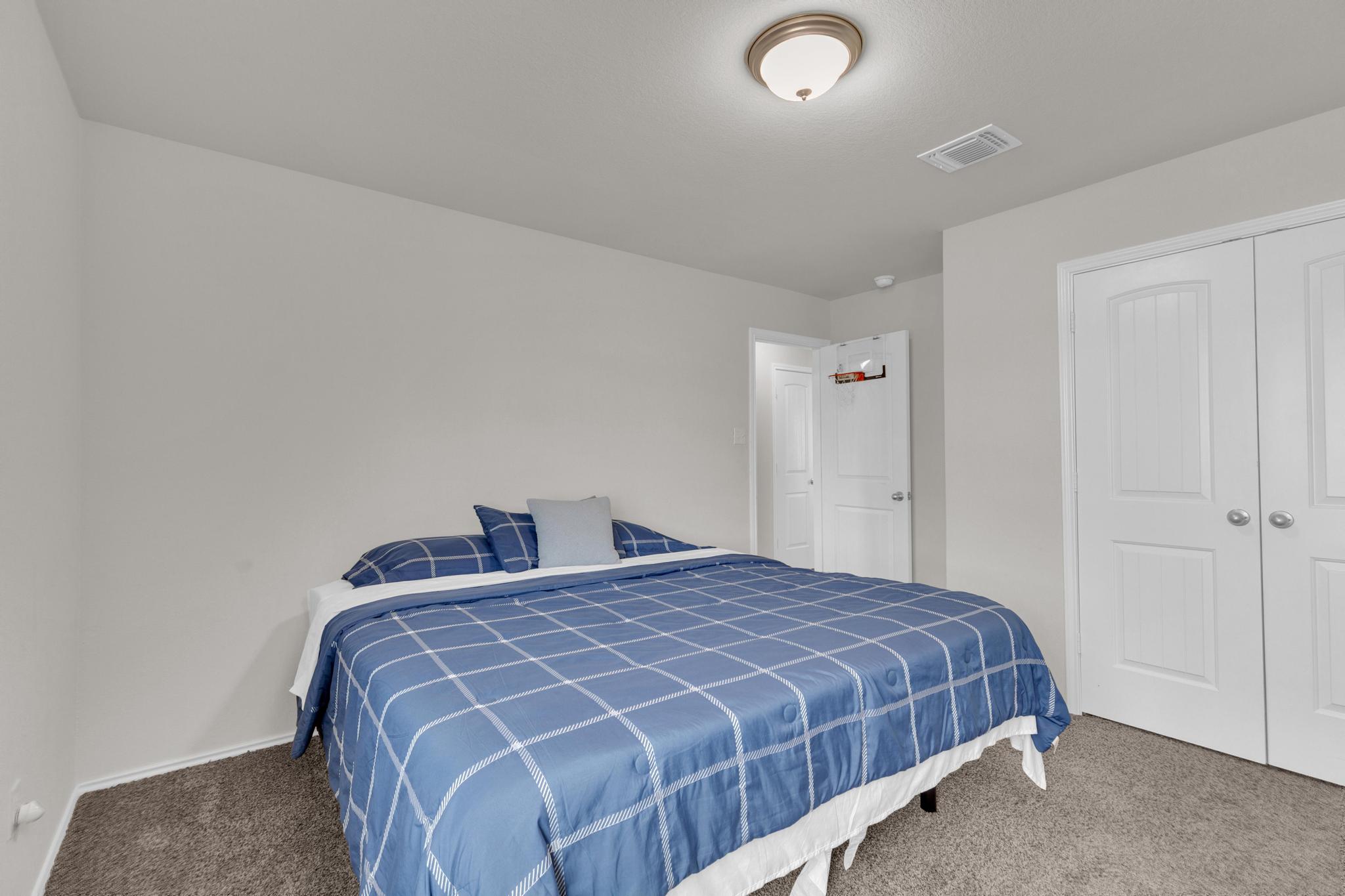 104 Uncle Billy Way Jarrell, TX 76537 - Photo 30 of 38 A well-lit bedroom provides ample space and a cozy atmosphere.