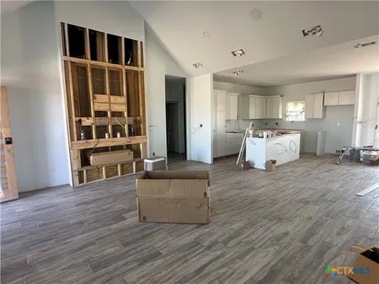 an open kitchen with refrigerator and window