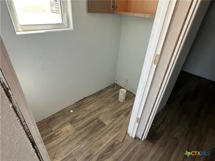 a hallway with furniture and wooden floor
