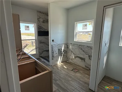 a view of a kitchen with wooden floor and furniture