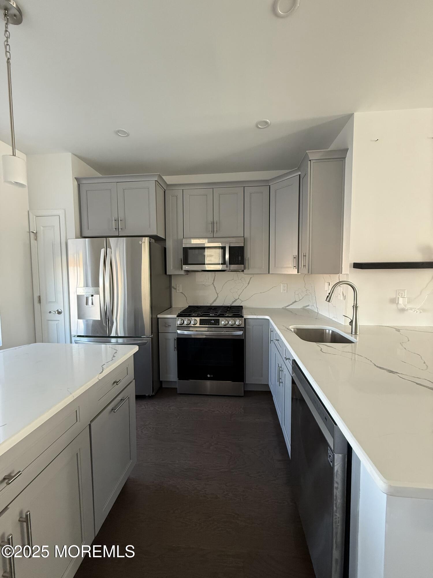 300 Prestige Road Brick, NJ 08723 - Photo 13 of 50 a kitchen with stainless steel appliances granite countertop a sink stove microwave and refrigerator