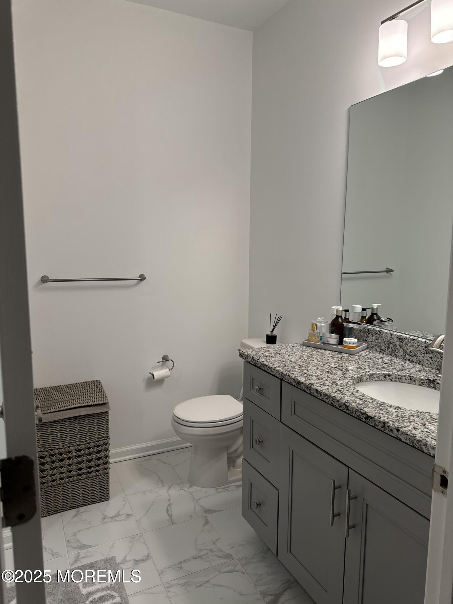 300 Prestige Road Brick, NJ 08723 - Photo 28 of 50 a bathroom with a granite countertop sink and a toilet