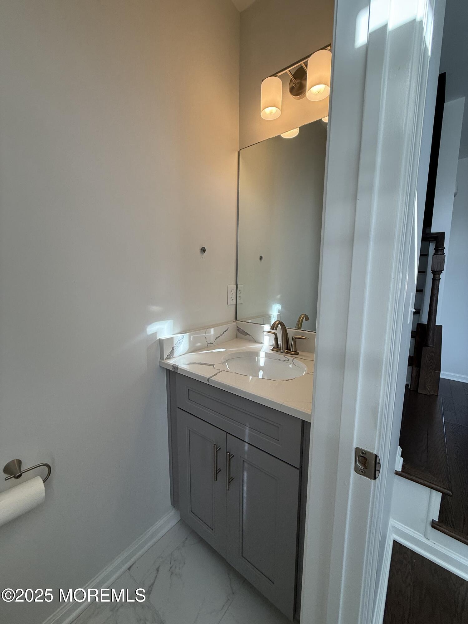 300 Prestige Road Brick, NJ 08723 - Photo 37 of 50 a bathroom with a granite countertop sink and a mirror