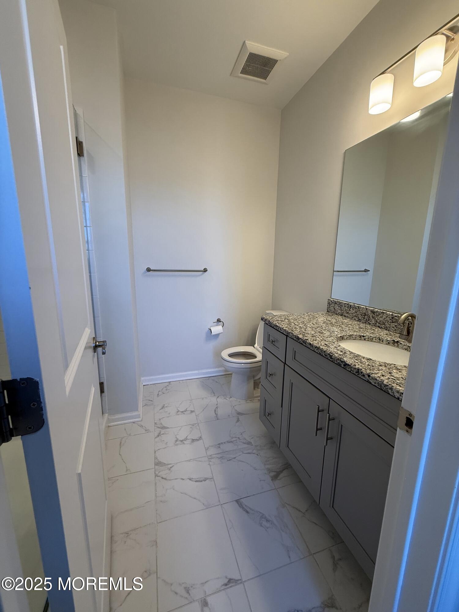 300 Prestige Road Brick, NJ 08723 - Photo 41 of 50 a bathroom with a granite countertop sink and a mirror