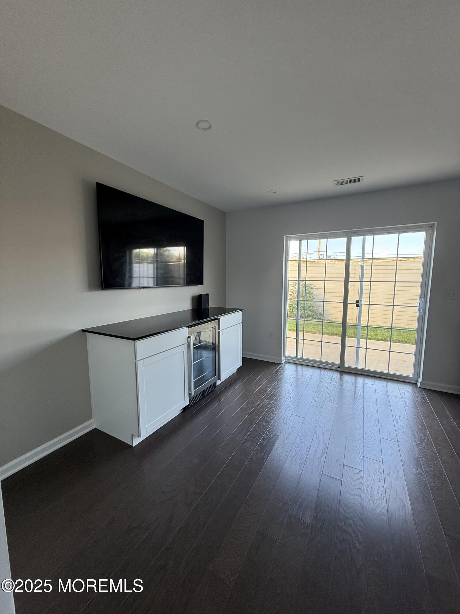 300 Prestige Road Brick, NJ 08723 - Photo 5 of 50 an empty room with wooden floor and windows