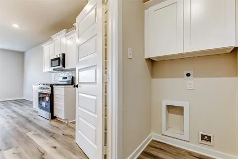 a kitchen with stainless steel appliances a stove sink microwave and cabinets
