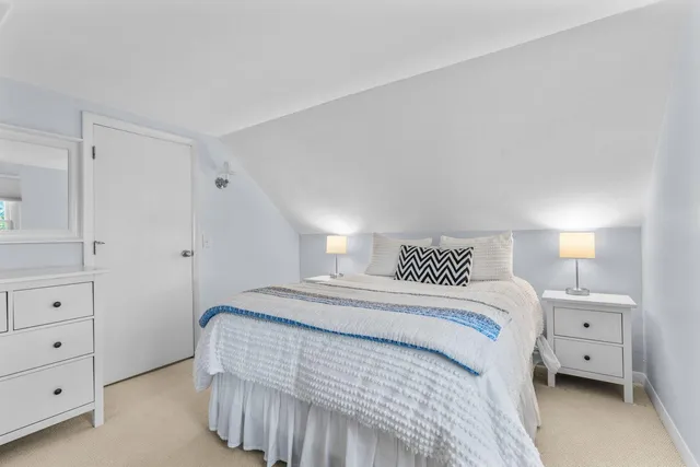 a view of a room with wooden floor and a window
