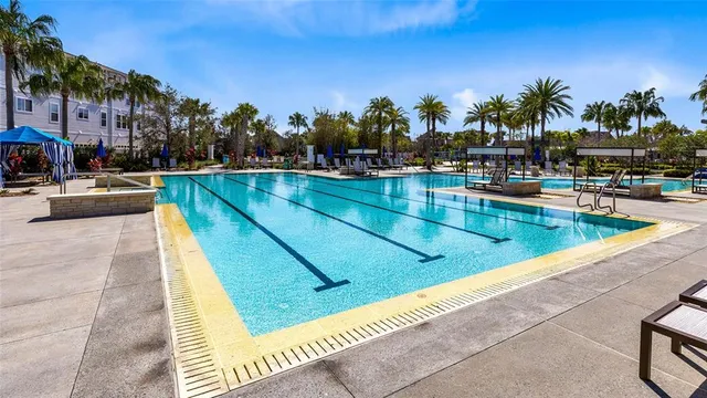 a view of swimming pool with outdoor seating and a garden