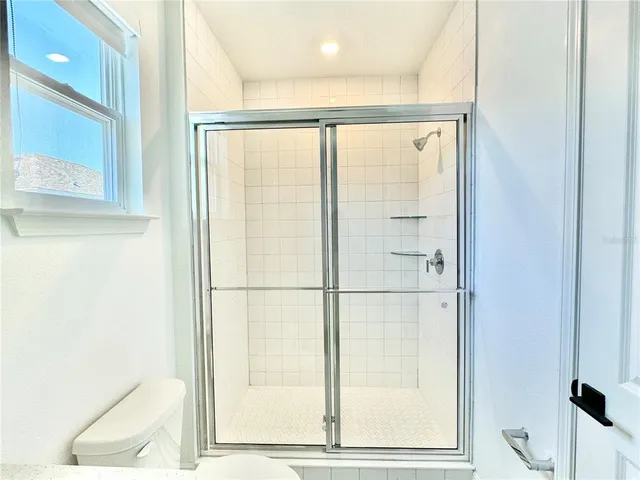 a bathroom with a glass shower door