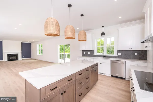 a kitchen with stainless steel appliances granite countertop a stove a oven a refrigerator and a sink