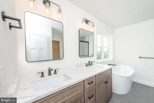 a bathroom with a double vanity sink and a mirror