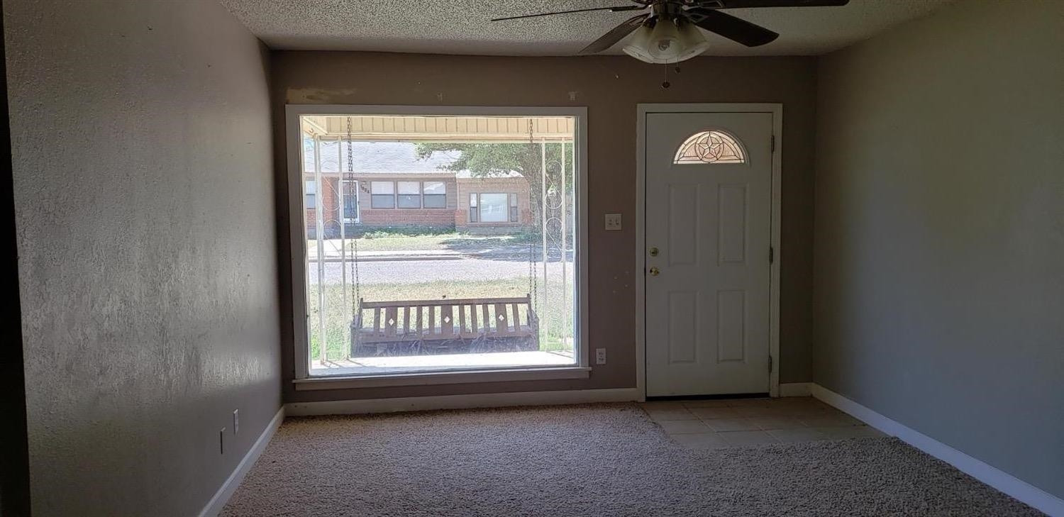 1007 2nd Street Plains, TX 79355 - Photo 9 of 11 a view of an empty room with a window