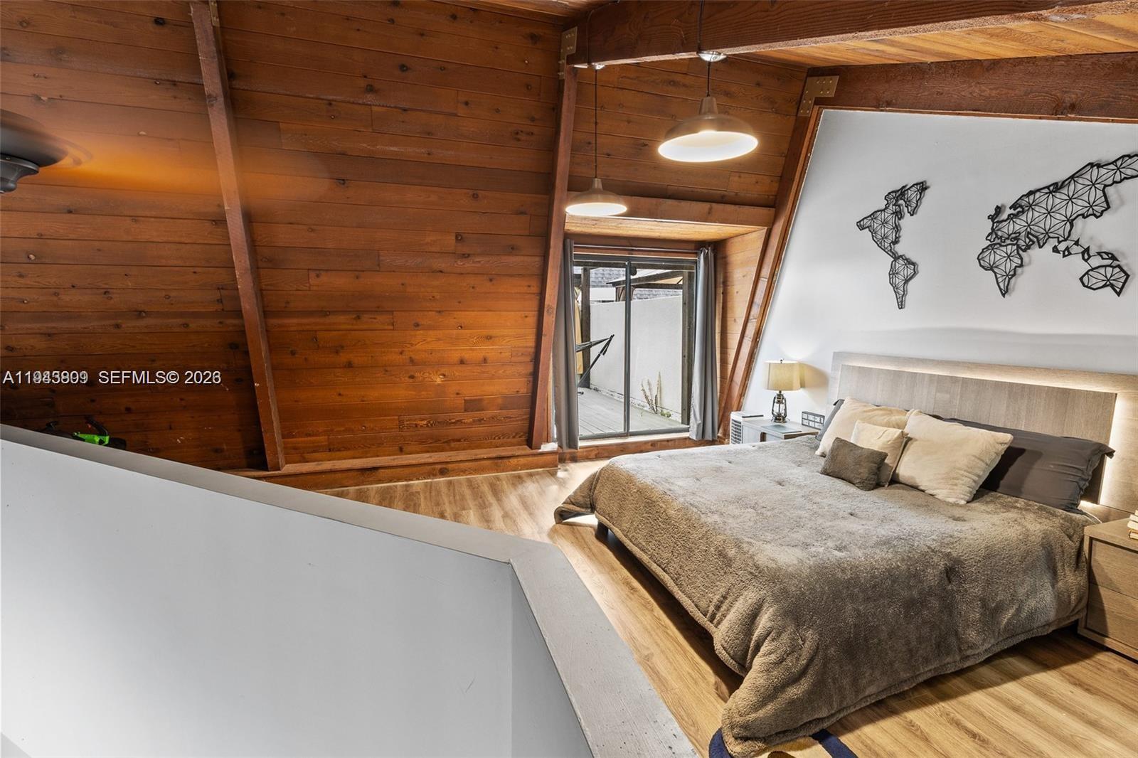 8331 Southwest 157th Avenue, Unit 409 Miami, FL 33193 - Photo 12 of 19 a bedroom with a bed and a painting on the wall