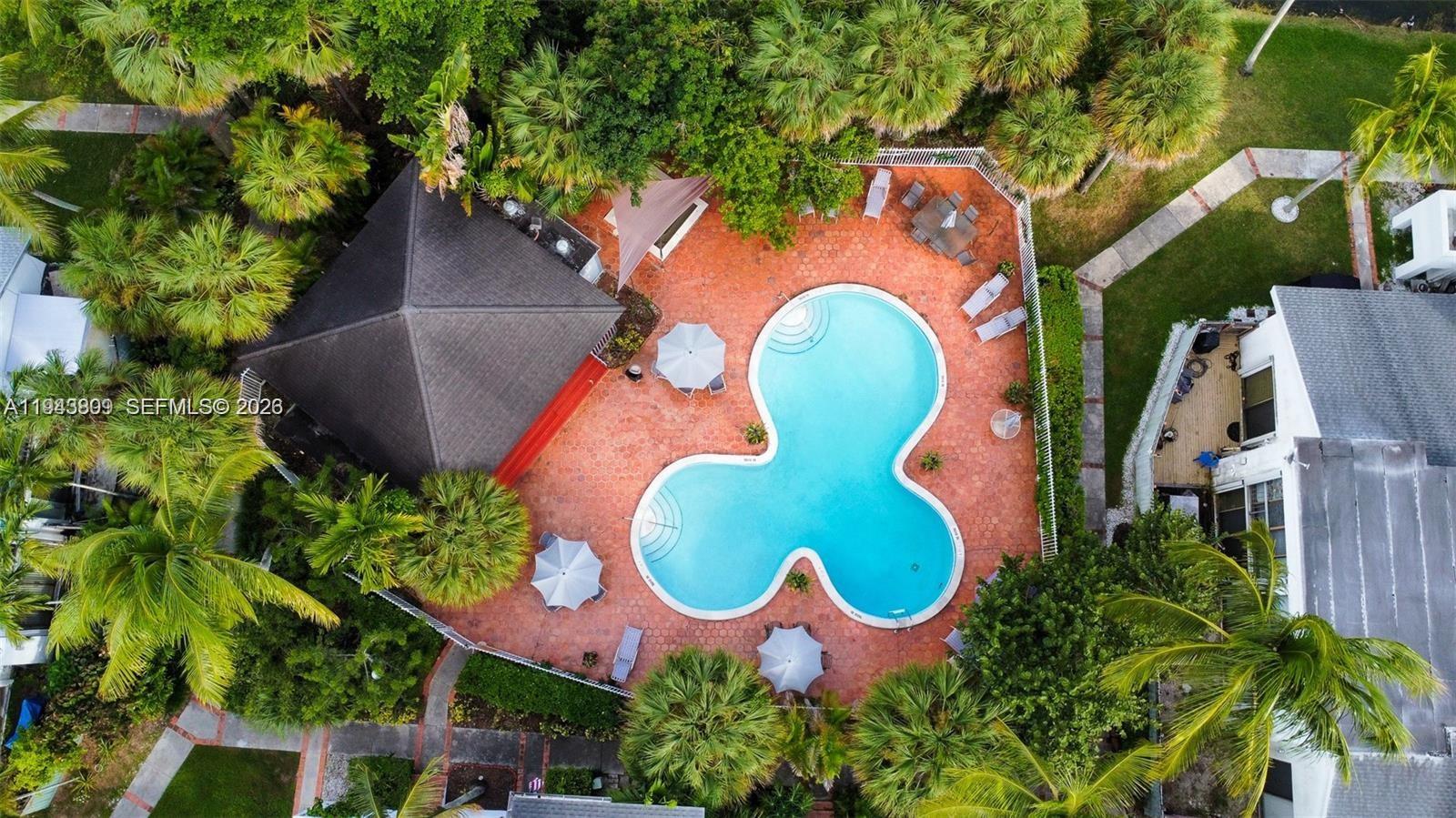 8331 Southwest 157th Avenue, Unit 409 Miami, FL 33193 - Photo 18 of 19 an aerial view of a swimming pool with outdoor seating and yard