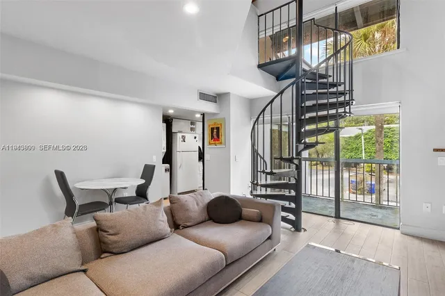 a living room with furniture and a floor to ceiling window