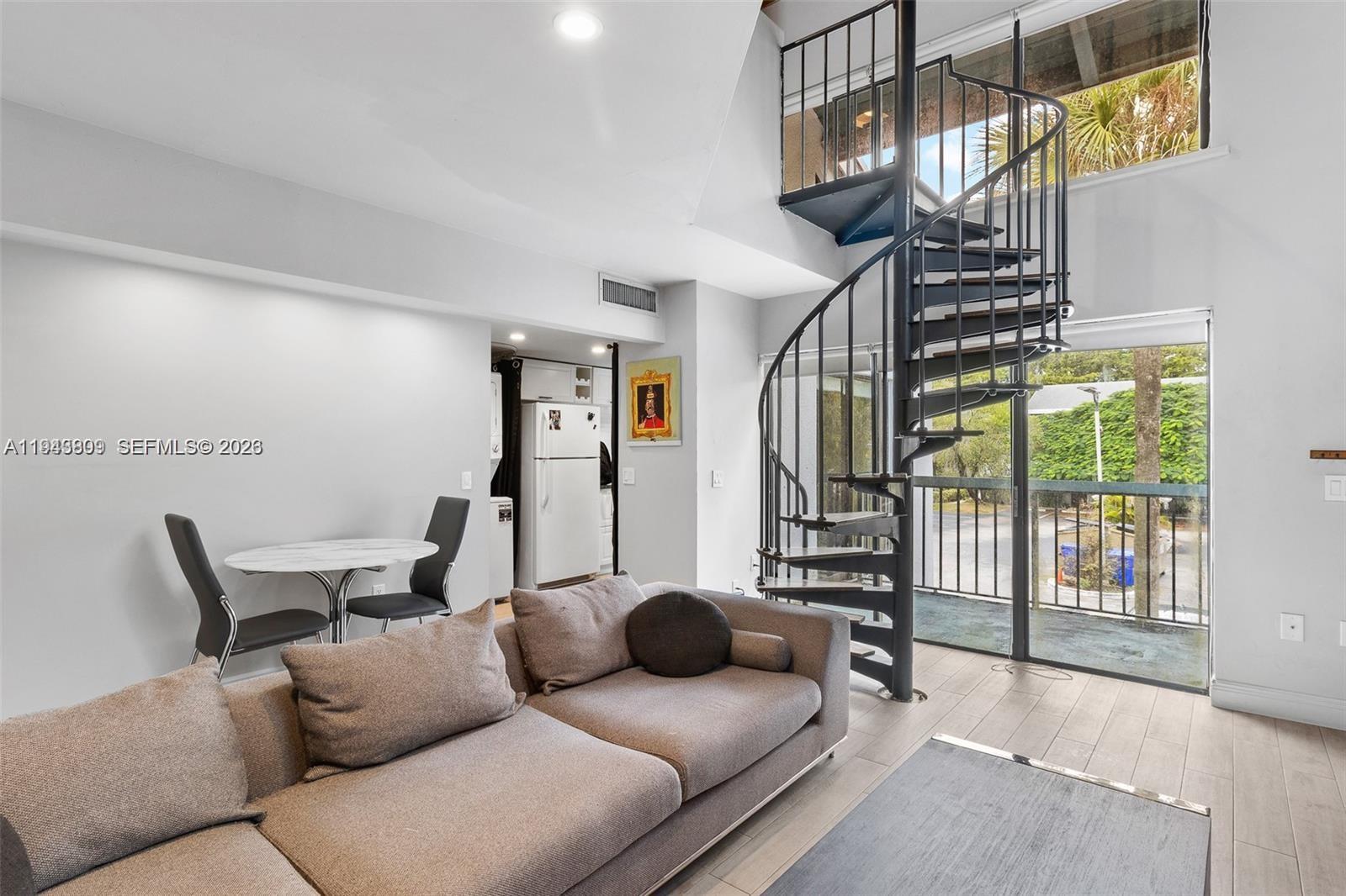 8331 Southwest 157th Avenue, Unit 409 Miami, FL 33193 - Photo 3 of 19 a living room with furniture and a floor to ceiling window