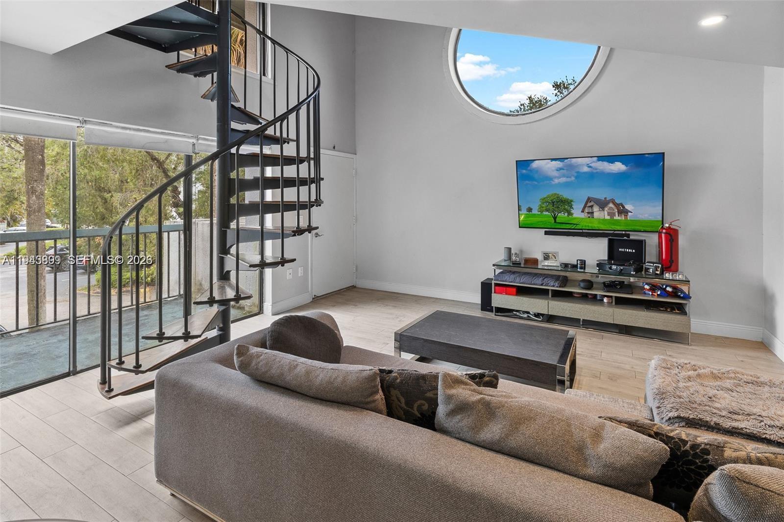 8331 Southwest 157th Avenue, Unit 409 Miami, FL 33193 - Photo 4 of 19 a living room with furniture and a flat screen tv