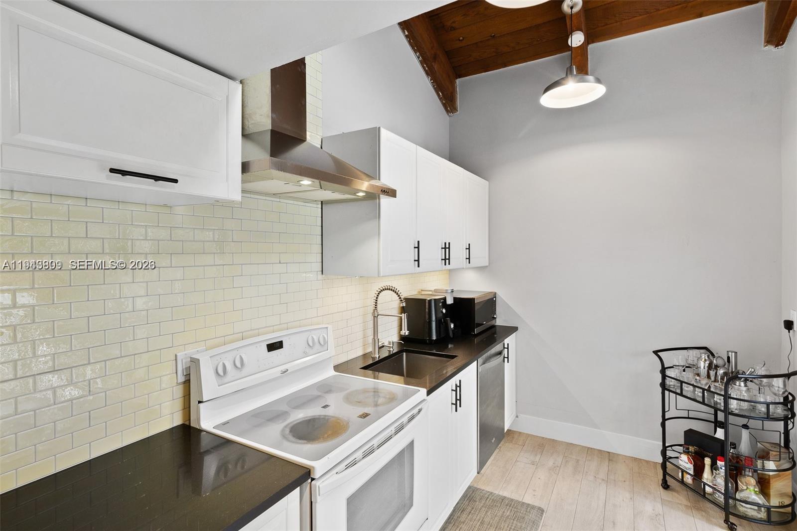 8331 Southwest 157th Avenue, Unit 409 Miami, FL 33193 - Photo 6 of 19 a kitchen that has a sink and a stove