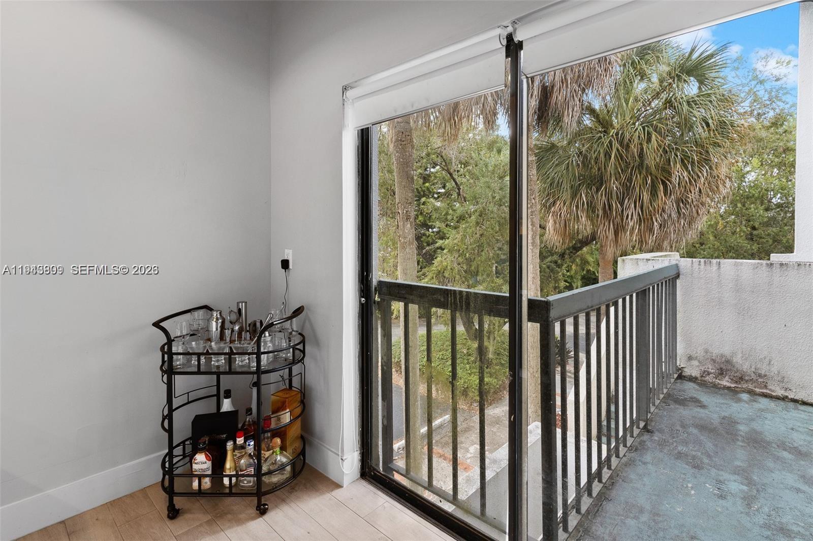 8331 Southwest 157th Avenue, Unit 409 Miami, FL 33193 - Photo 7 of 19 a view of a porch with wooden floor