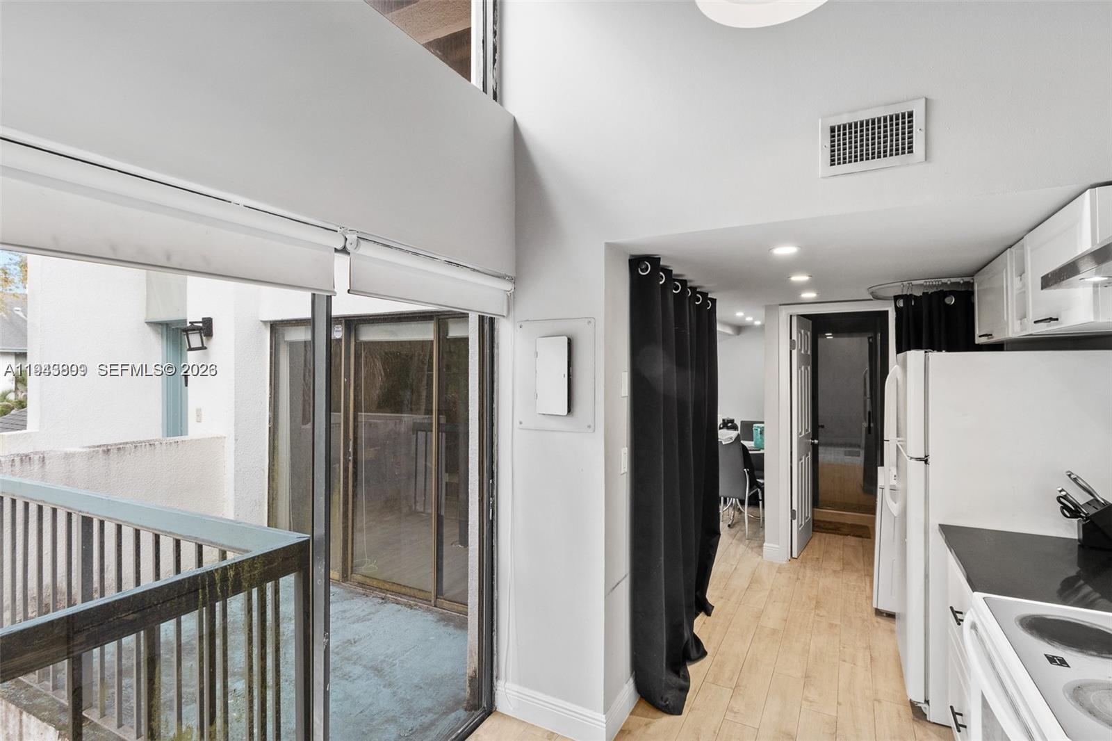 8331 Southwest 157th Avenue, Unit 409 Miami, FL 33193 - Photo 8 of 19 a view of a hallway with bathroom and wooden floor