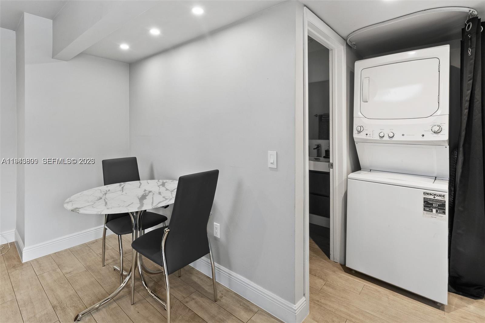 8331 Southwest 157th Avenue, Unit 409 Miami, FL 33193 - Photo 9 of 19 a workspace with furniture and wooden floor