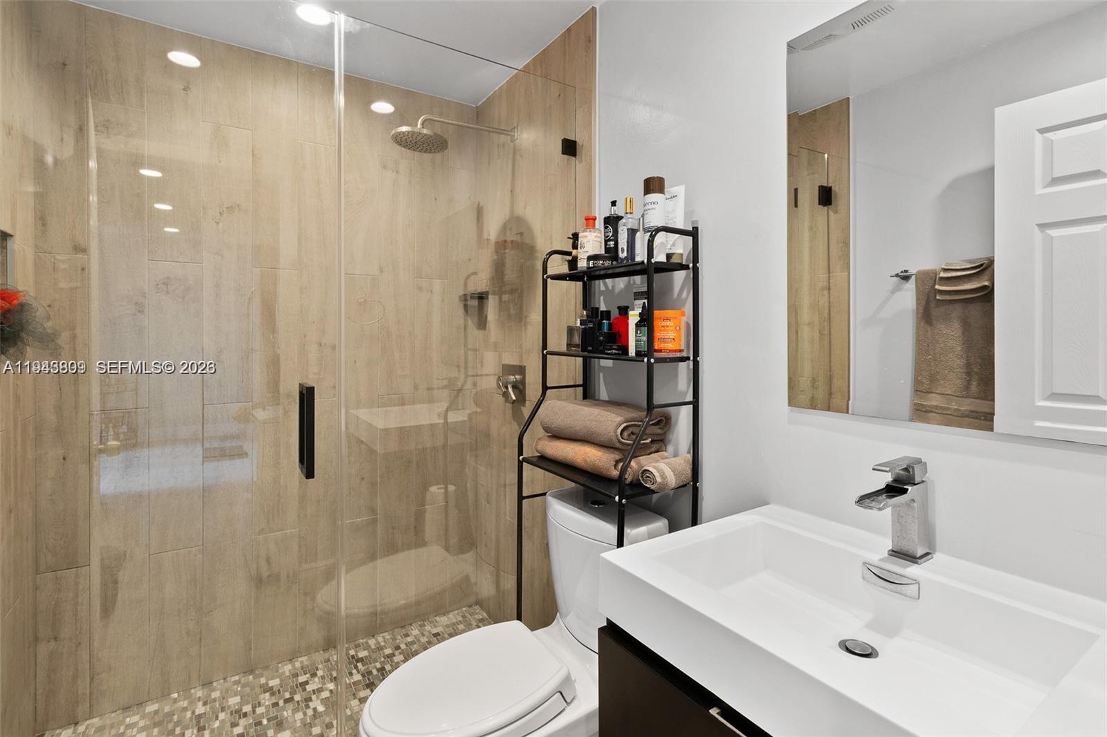 8331 Southwest 157th Avenue, Unit 409 Miami, FL 33193 - Photo 10 of 19 a bathroom with a sink toilet and shower