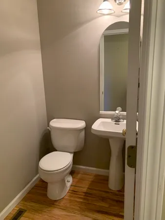 a white toilet sitting next to a bathroom sink