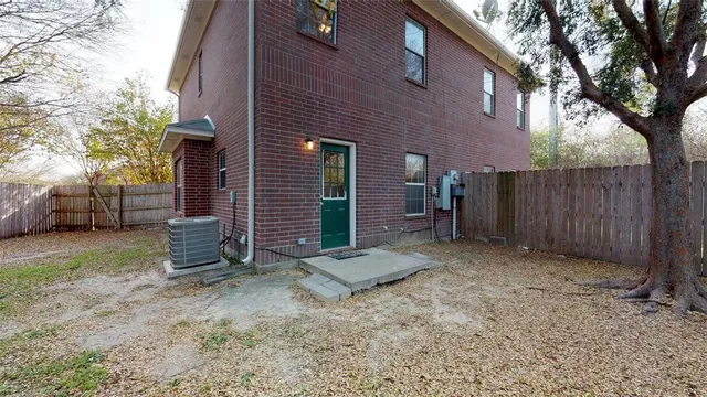 a view of a house with a yard and tree