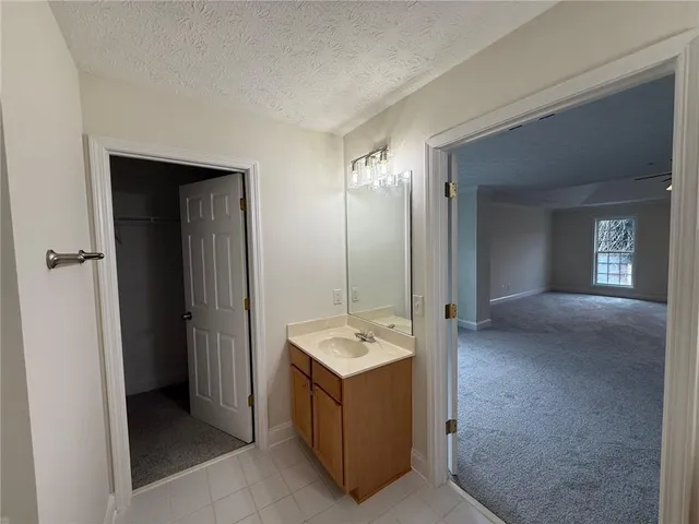 a bathroom with a tub a sink and mirror