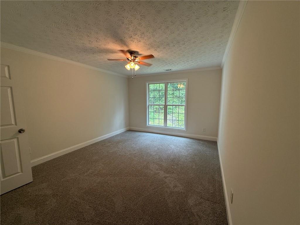 2966 Fairton Trail Lithonia, GA 30038 - Photo 22 of 28 an empty room with windows and chandelier fan