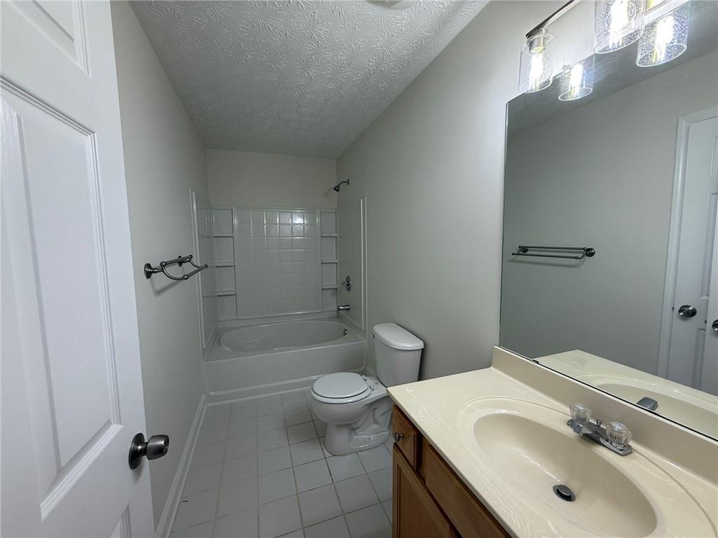 2966 Fairton Trail Lithonia, GA 30038 - Photo 23 of 28 a bathroom with a sink a toilet and shower