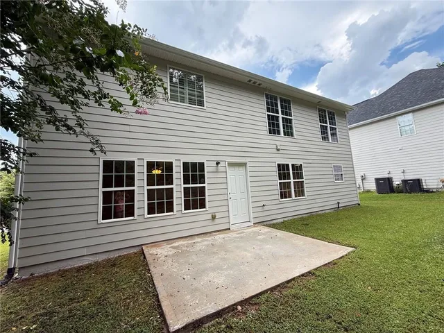 a view of a house with a door and wooden walls