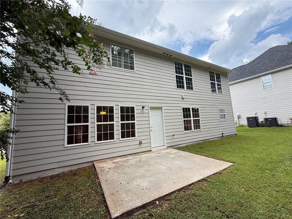 2966 Fairton Trail Lithonia, GA 30038 - Photo 25 of 28 a front view of a house with a yard
