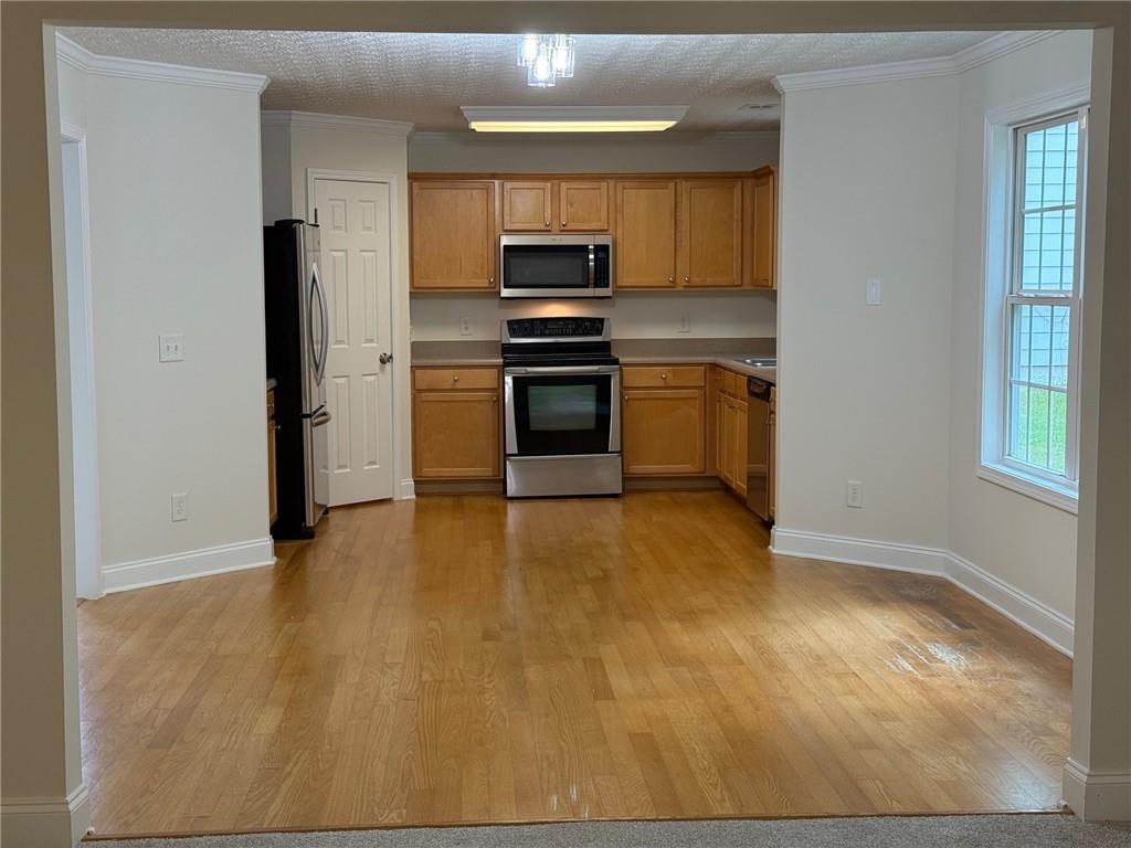 2966 Fairton Trail Lithonia, GA 30038 - Photo 5 of 28 a kitchen with granite countertop a stove and a refrigerator