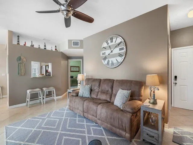 a living room with furniture and view of kitchen