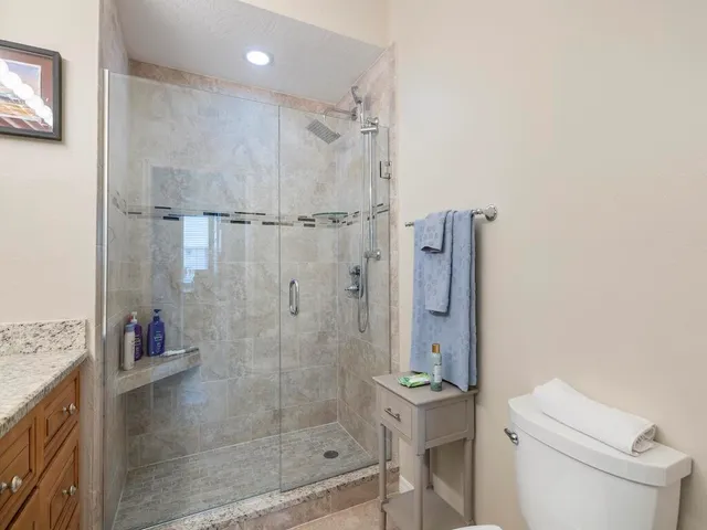 a bathroom with a shower a toilet and sink