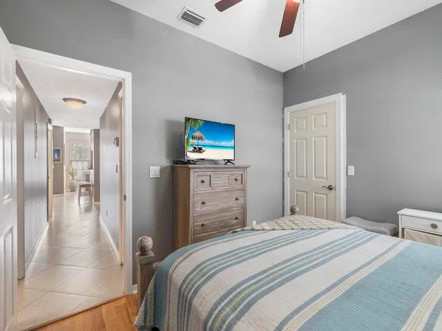 a bedroom with a bed and a television