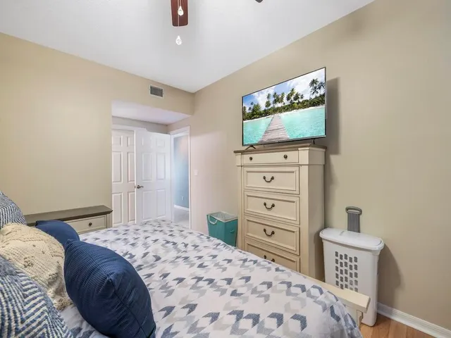 a bedroom with a bed and a flat screen tv in it