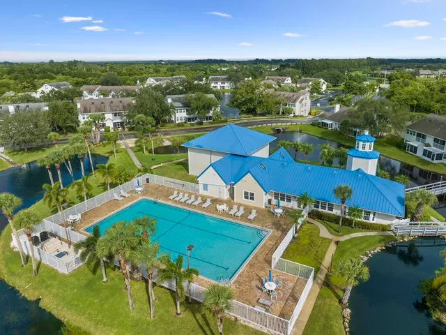 an aerial view of a house with a swimming pool outdoor seating and yard