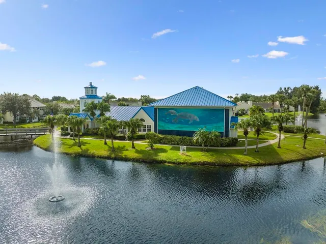a view of a house with swimming pool and a yard