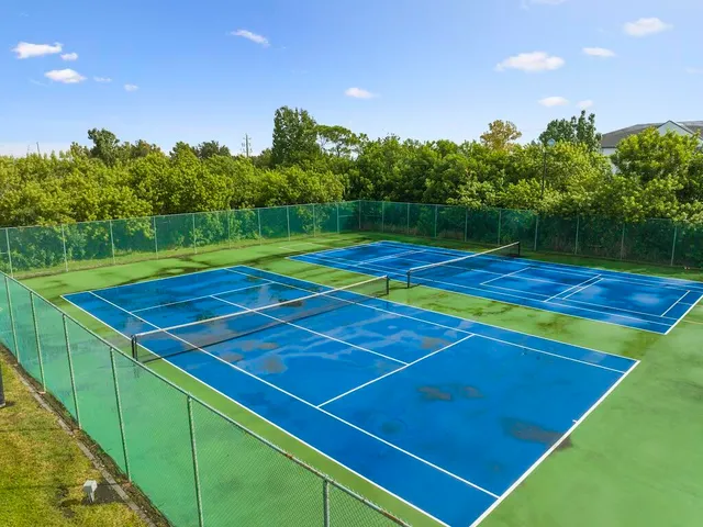 a view of an outdoor space and tennis court