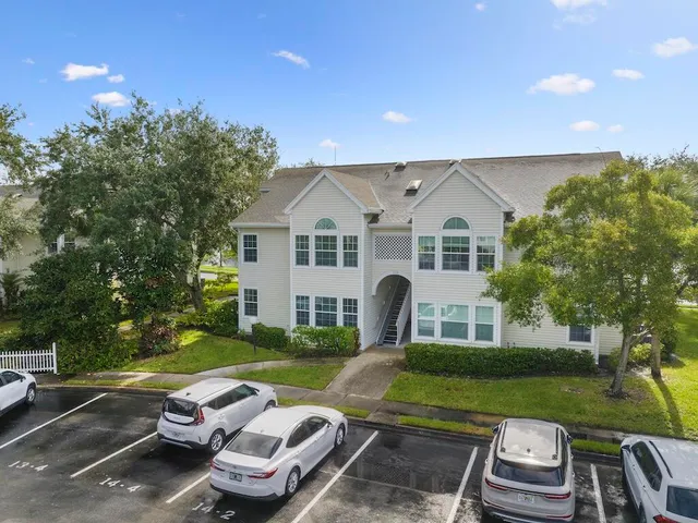 a view of a white house with a yard