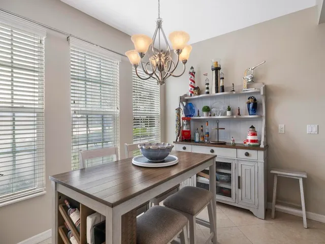 a kitchen with a kitchen island a stove a table and chairs