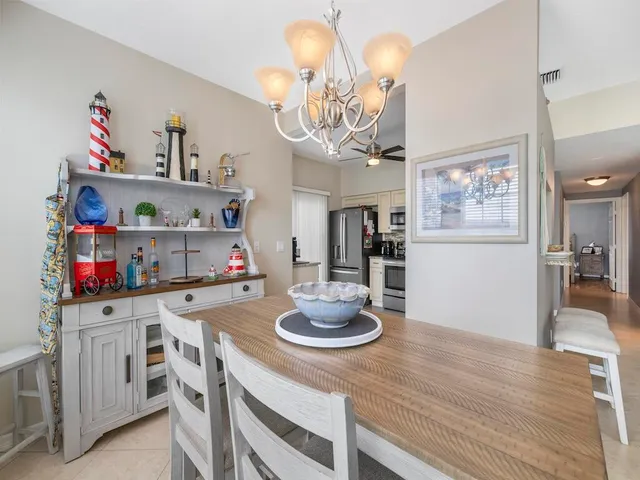 a kitchen with a dining table and wooden floor