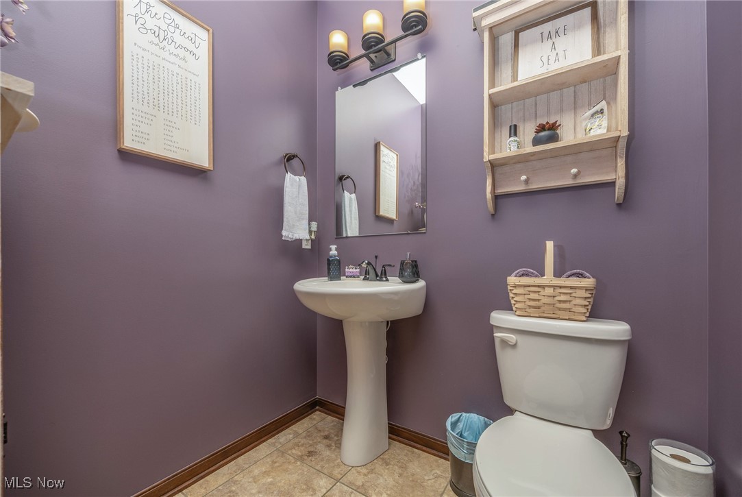 2851 Barnett Ridge Road Fleming, OH 45729 - Photo 11 of 40 Half Bathroom with baseboards, toilet, tile patterned floors, and a sink