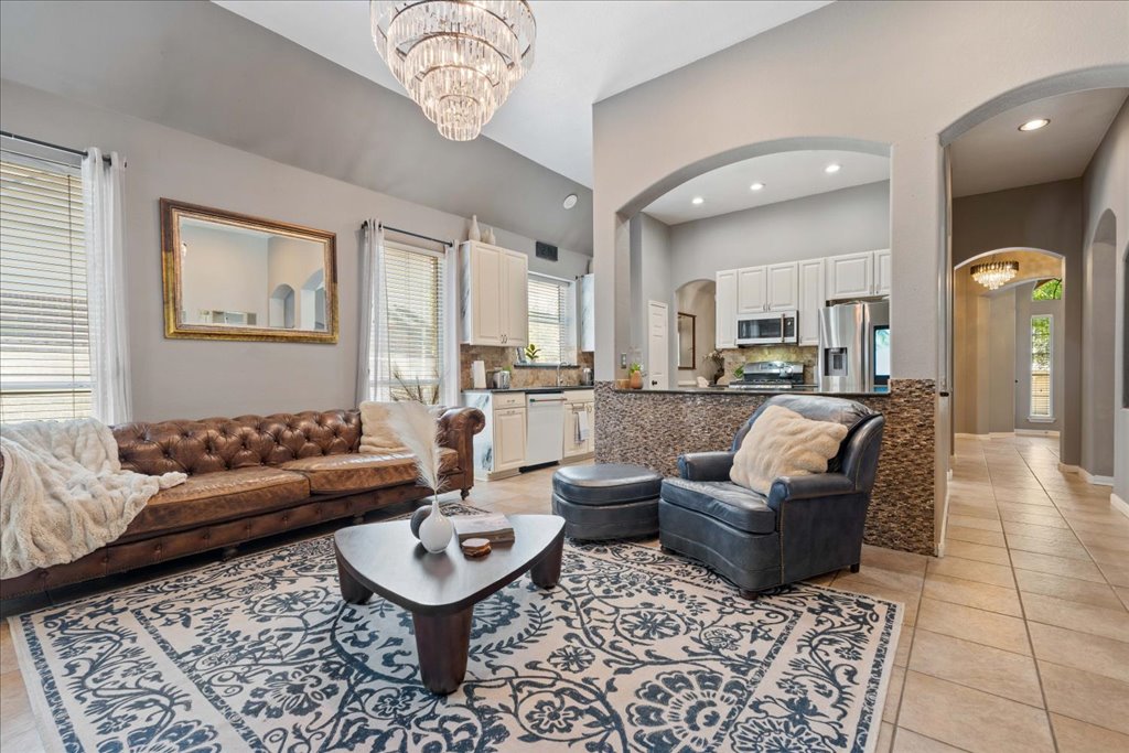 1505 Laurel Oak Loop Round Rock, TX 78665 - Photo 14 of 40 a living room with furniture and a chandelier