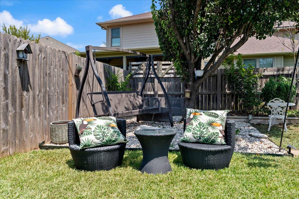 1505 Laurel Oak Loop Round Rock, TX 78665 - Photo 16 of 40 a view of a backyard with table and chairs potted plants and a fire pit