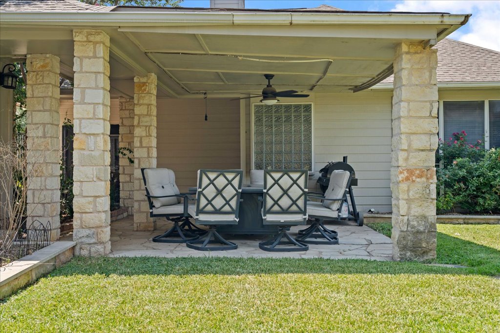 1505 Laurel Oak Loop Round Rock, TX 78665 - Photo 19 of 40 a view of a patio with table and chairs near a yard