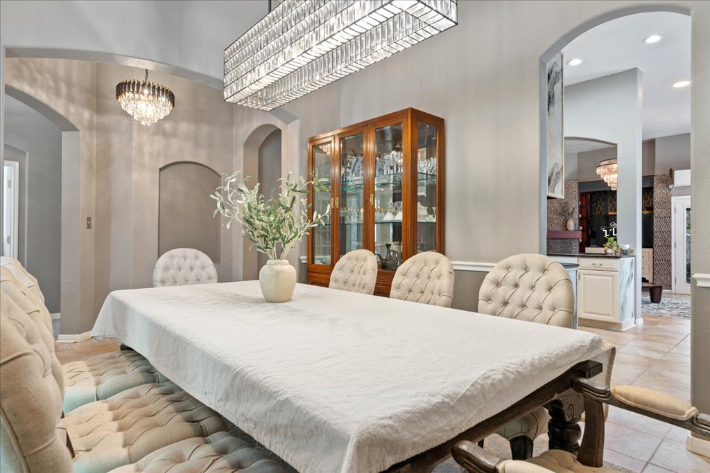 1505 Laurel Oak Loop Round Rock, TX 78665 - Photo 10 of 40 a bedroom with a large bed and a chandelier